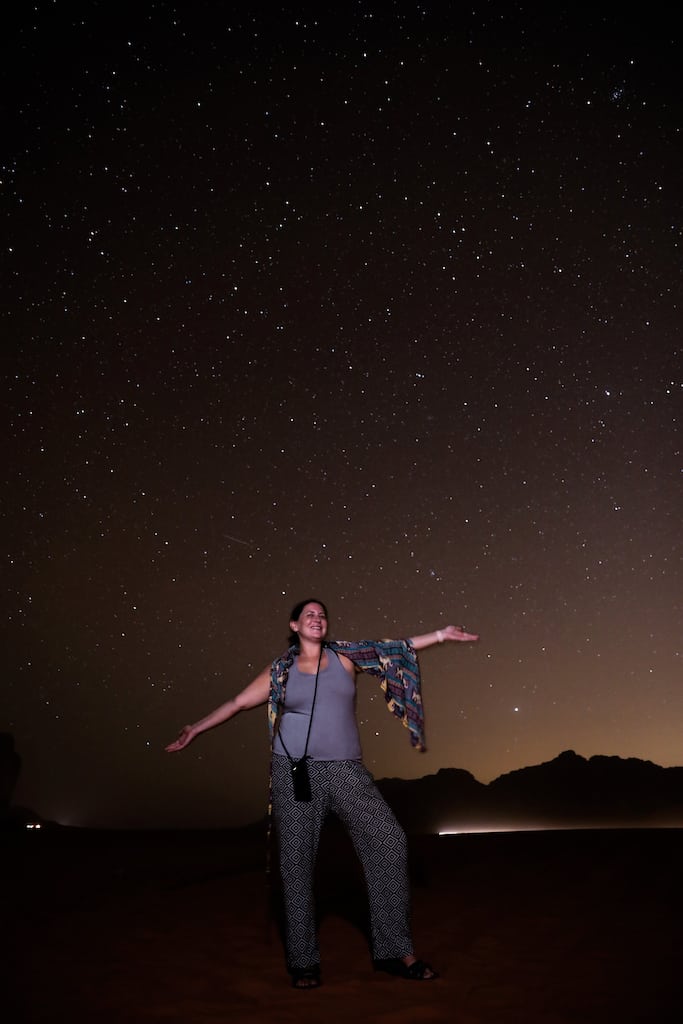 Me standing in the Wadi Rum desert at night with a sky full of stars above me.