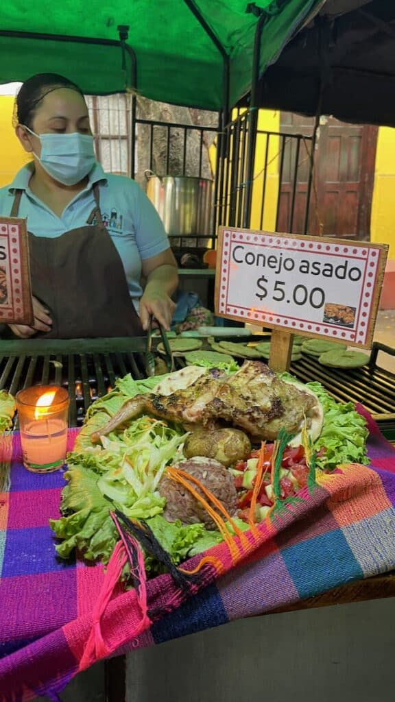 Picture of a plate of grilled rabbit at a food stand in Juayua's weekend food festival, in El Salvador.