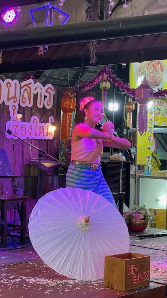A traditionally dressed female Thai dancer performs a dance at the Night Bazaar in Chiang Mai.