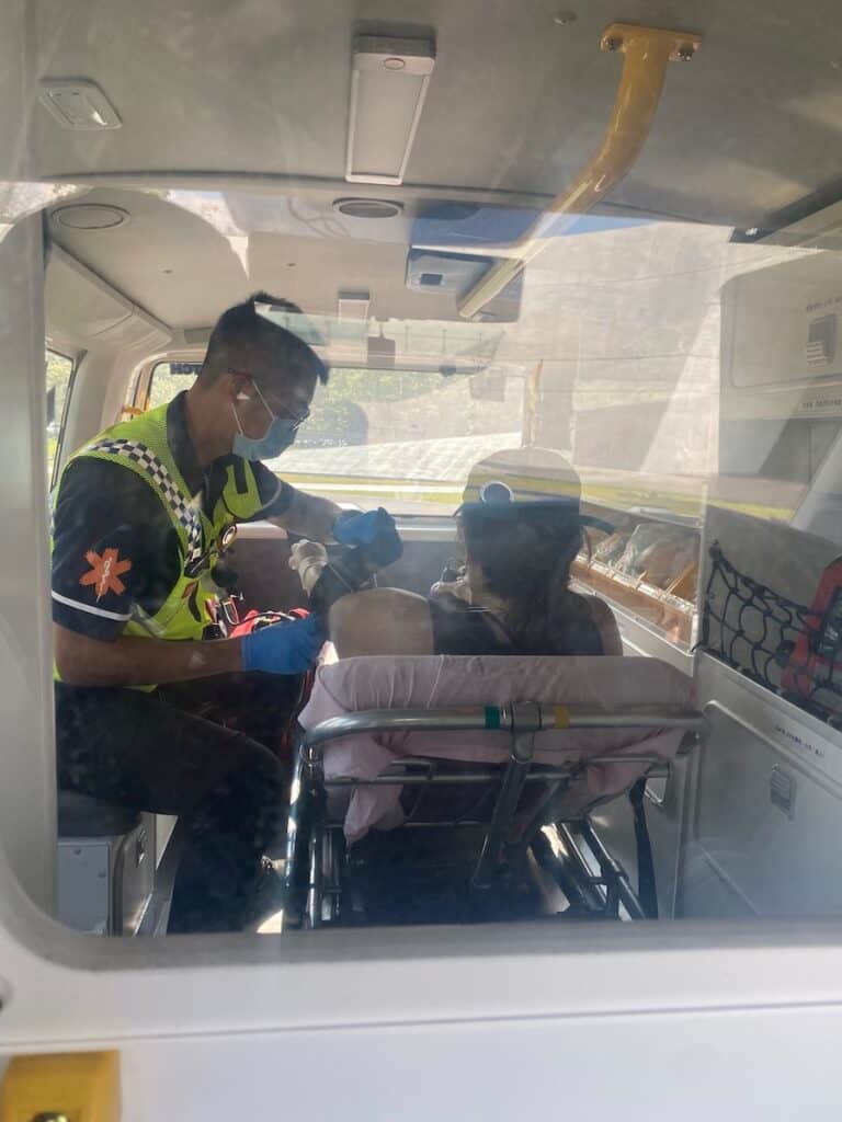 Photo of me in the back of an ambulance getting my blood pressure taken.